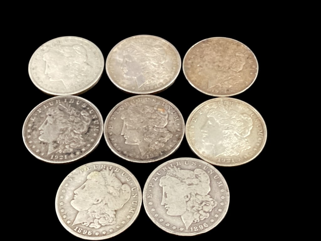 Eight Morgan Silver Dollars: Circulated with wear. Dates are 2- at 1896, and six 1921. - ()
