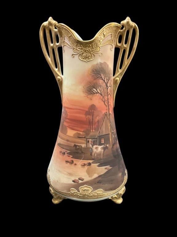 Nippon Porcelain Vase: Nippon Porcelain Vase Lovely Hand Painted Vase with landscape scene and ornate gilt trimmed handles. 17.5 inches tall diameter with. Footed form with raised enamels in Moriage style Line Item # 102
