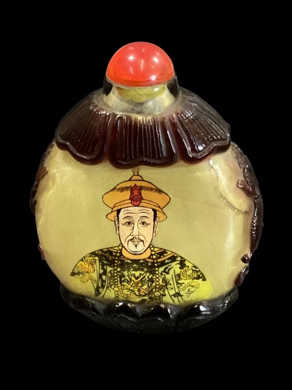 Chinese Reverse Painted Snuff Bottle: Chinese Reverse Painted Snuff Bottle Reverse painted bottle displaying the Kangi Emperor Yongzheng. Amethyst cut collar and base, with trailing dragons. Red glass cap. Verso with script for the