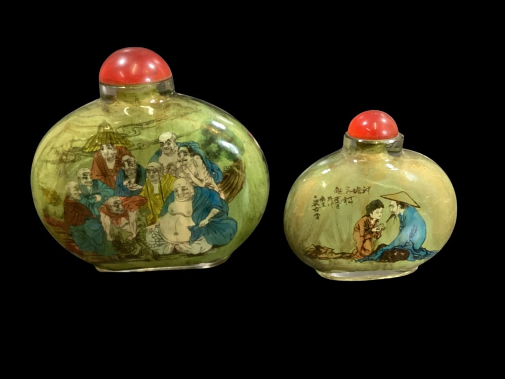 Two Chinese Snuff Bottles: Two Chinese Snuff Bottles Reverse Painted, the larger bottle depicts a group of scholars reading a scroll, reverse with similar. 5 x 5 inches. Similar reverse painted on glass with farmer and cow,