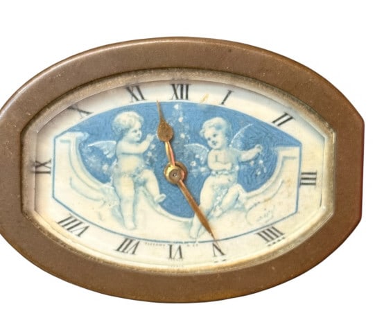 French Brass Cherub Boudoir Clock for Tiffany: French Brass Cherub Boudoir Clock for Tiffany Antique French miniature brass boudoir or desk clock retailed by Tiffany & Co. Features an oval-shaped matte brass bezel enclosing a pictorial dial face.