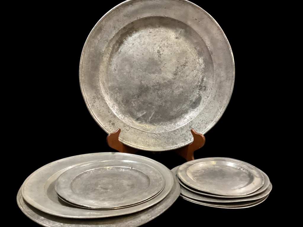 Pewter Chargers and Plates: Oversized 18 inch Charger, well worn stamped EP. 15 inches tall jug deep well dish, 14 inch London tray, Colonial 10 inch stamped by makers initials. 5 graduated size plates. 10 pieces total Line
