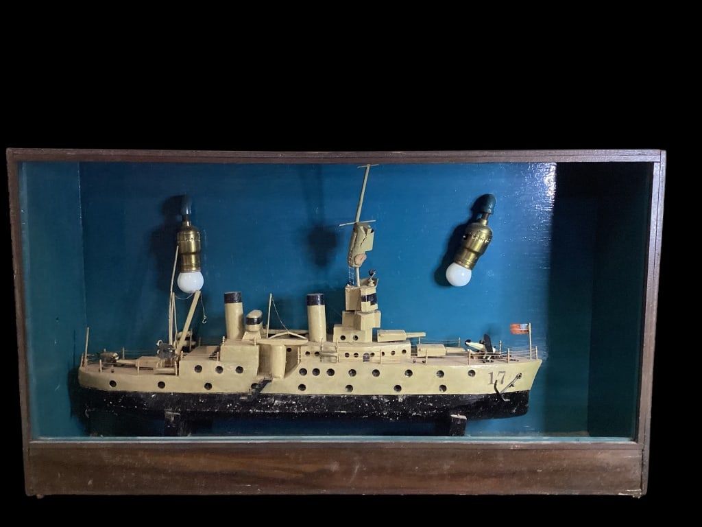Wood Ship Diorama: Cased Diorama display of Naval Warship, possibly a cruiser or battle ship, complete with duel smokestacks, gun turrets, and portholes. Electrified display case measures 29 x 16 inches, ship alone at
