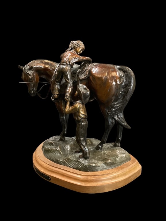 Western Theme Sculpture: Artist Cloyd Barnes, Titled A Helping Hand, depicting a young cow boy helping a girl into saddle. 11 x 12 inches, limited edition #59/100, dated 2001.