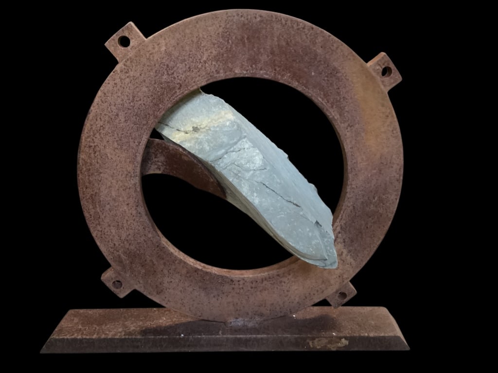 Sisyphean Circle Sculpture: Unique abstract sculpture created by Artist John Van Alstine, known for his creative process of balancing raw heavy stone with industrial steel. Here presented in slate point on heavy steel. Base at