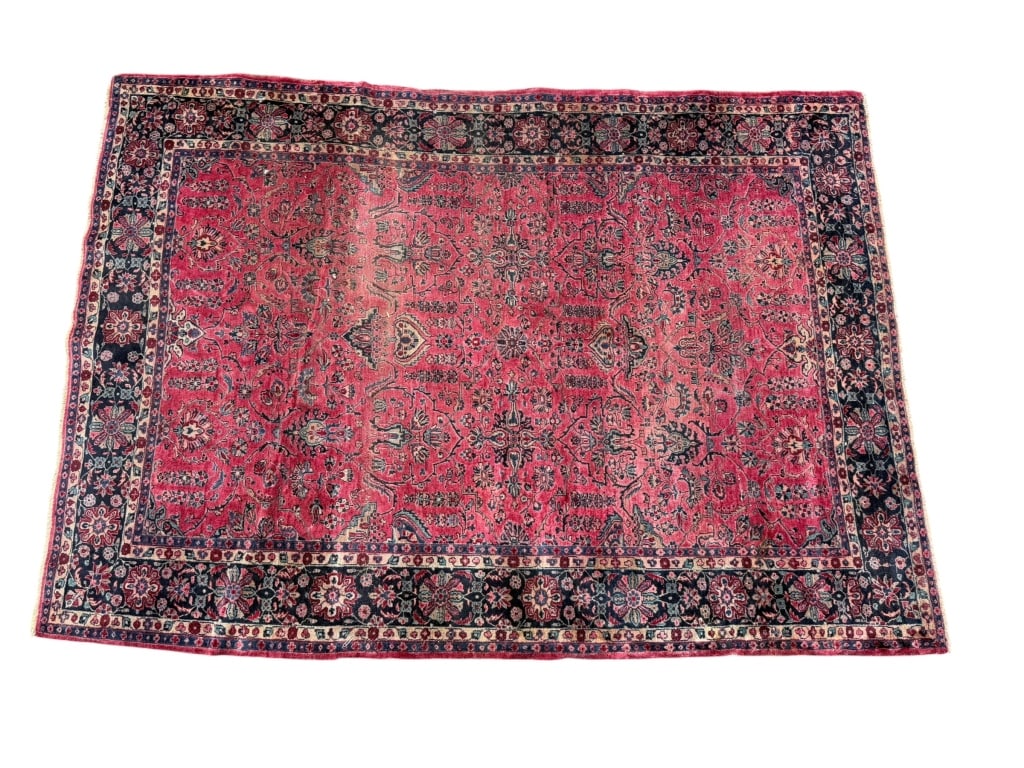 Persian Sarouk Wool Rug: Antique Persian Sarouk hand-knotted wool rug featuring a vibrant rose-red field surrounded by an intricate dark floral border. The traditional floral design and rich contrasting palette are
