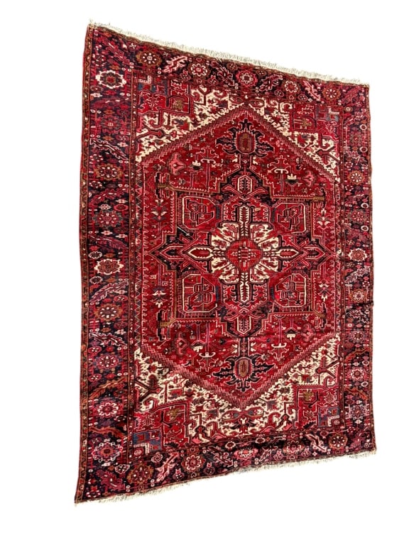 Heriz Wool Area Rug: Vintage Persian Heriz hand-knotted wool area rug featuring a striking red and ivory geometric central medallion. The bold angular motifs and contrasting palette are characteristic of the traditional