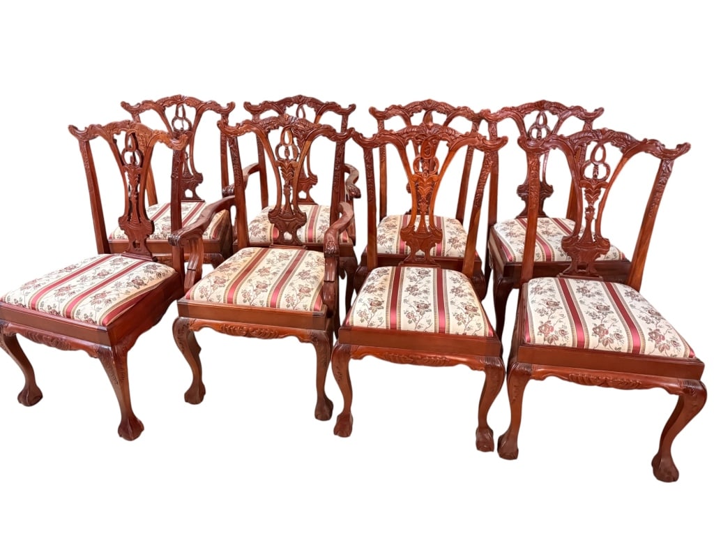 Set of Chippendale-Style Carved Dining Chairs: Pierced vase-form splats centered on carved husk and ribbon motifs, flanked by molded and leaf-carved uprights below scrolled and shell-carved crest rails. Serpentine seat rails on acanthus-carved