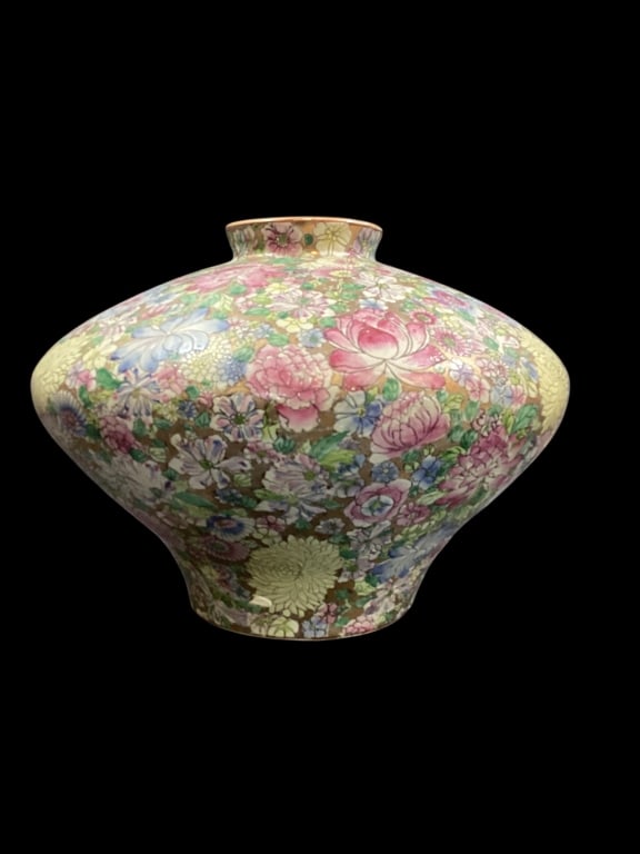 Chinese Porcelain Vase: Oversized axe in a dense floral pattern identified as Thousand Flowers, naturalistic blooms including Lotus flowers symbolizing Blessings. 16 x 14 inches wide wide bulbous body, base with red seal