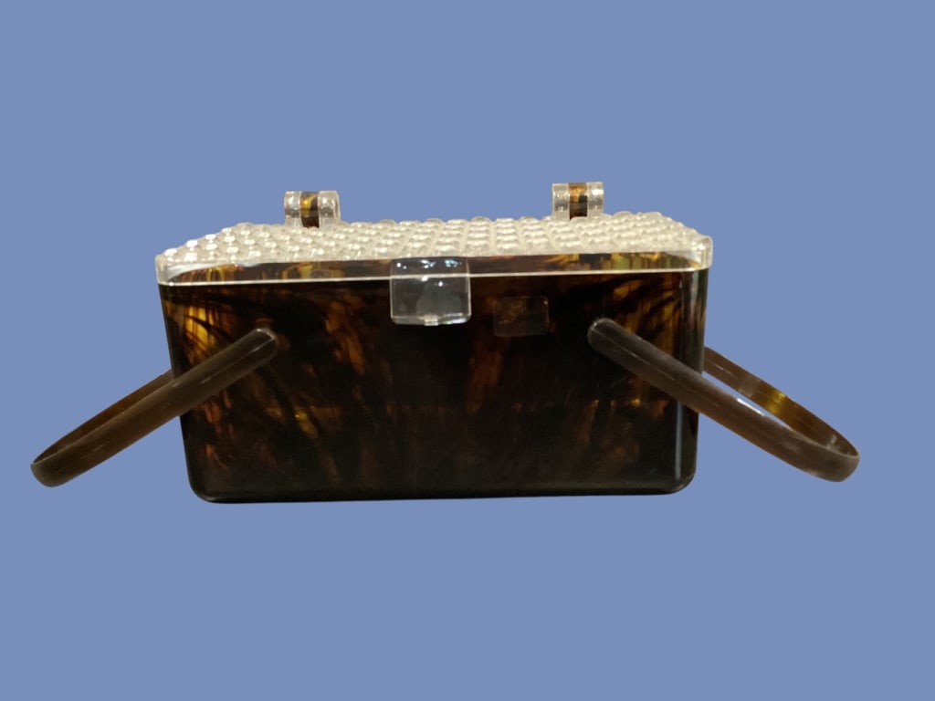 Mid Century Modern Lucite Box Bag: Translucent dark brown tortoiseshell patterned lucite, rectangular form, with clear lucite raised geometric cube design, often called waffle pattern. Double swing torti handles, with fixed clear back