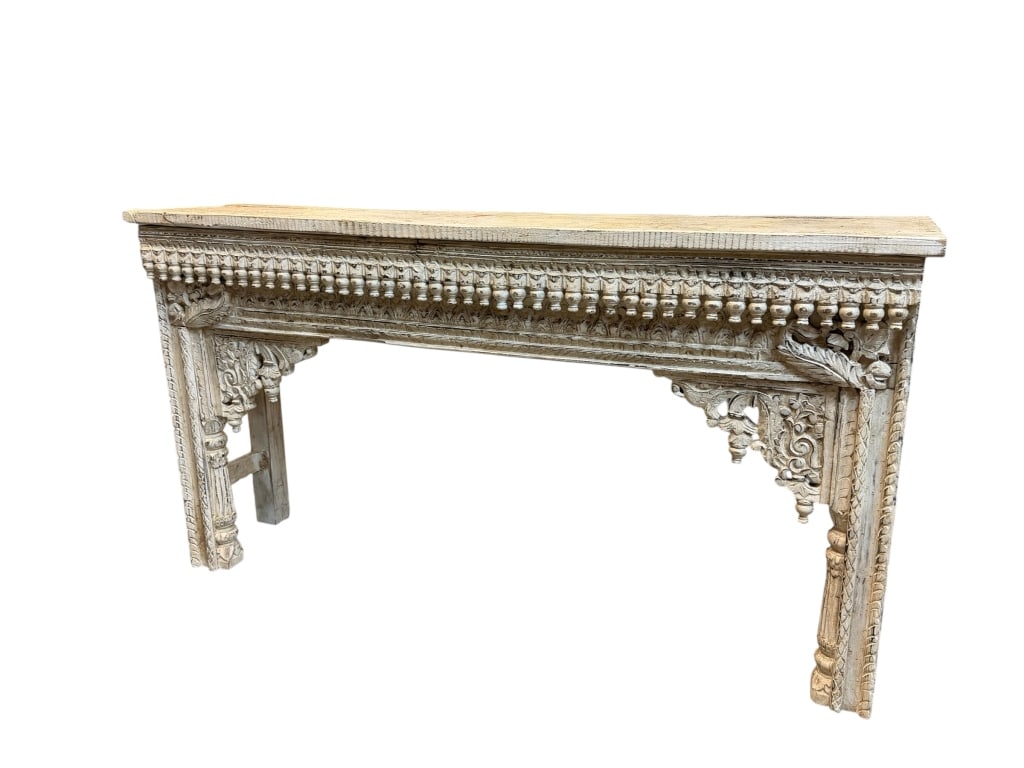 Wooden Console Table in South Asian Style: Hand-carved wooden console table featuring a distressed whitewashed finish and architectural details inspired by traditional South Asian design. The carved ornament and weathered finish give the