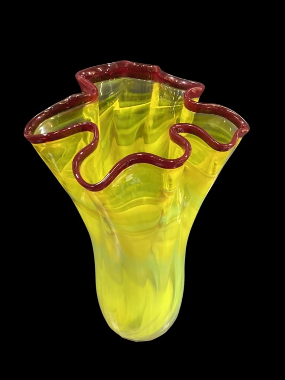 Mid Century Art Glass: Vibrant Murano style hand blown handkerchief vase. Distinctive ruffled rim with a bold red edge on swirling egg yoke yellow body. Studio artist, 29 inches tall, signed on base