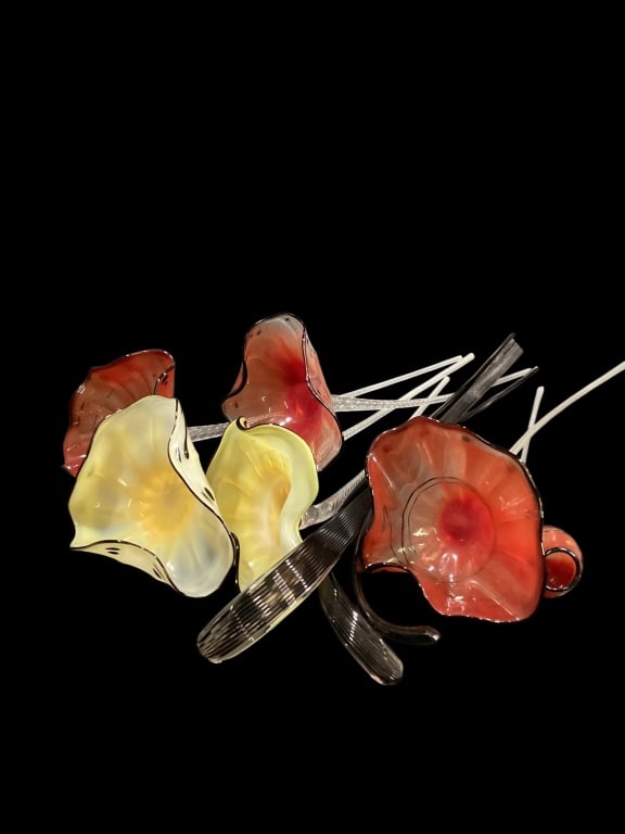 Hand Blown Glass Flowers: Five hand blown glass flowers with colored blood, in style of Murano.21 inches in length, 15 inch small bloom ,and three glass leaves or stems, in black mottling. 9 pieces total