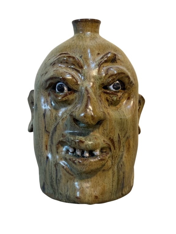 Marvin Bailey Face Jug: Southern folk art face jug by Marvin Bailey featuring a traditional tobacco-spit alkaline glaze, giving the surface a mottled brown and olive finish with darker pooling around the facial features.
