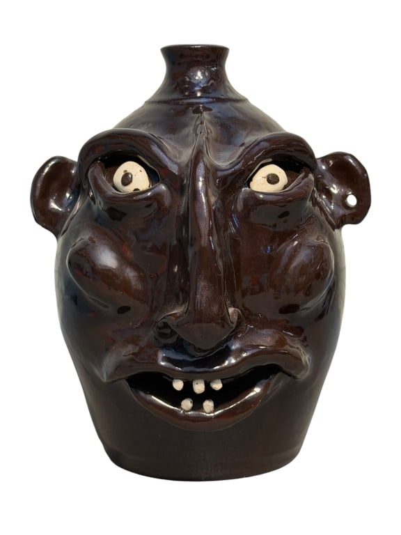 Jeff Standridge Face Jug: Southern folk art face jug by Georgia potter Jeff Standridge, dated 2000. The wheel-thrown stoneware jug features dramatic deep-set eyes, small stylized ears, a pinched elongated nose, and white