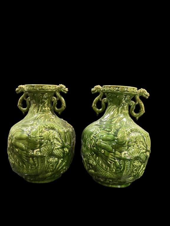 Vintage Asian Dragon Vases: Glazed ceramic Hu shaped jars, with traditional Chinese design featuring undulating dragon, with duel dragon shaped handles, deep Celedon green glaze. 14 inches tall