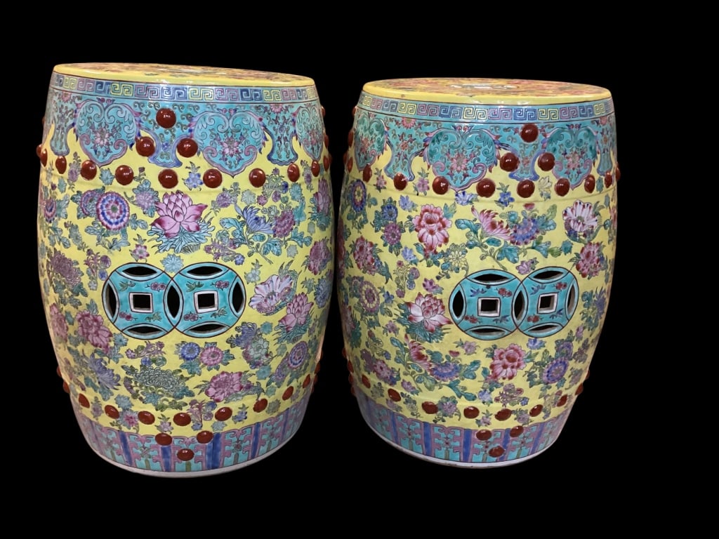 Pair Chinese Famille Garden Stools: Porcelain Famille Jaune Garden stools, vibrant yellow ground covered in overlay of scrolling floral vines and lotus motifs. Detailed rims with light blue and pink geometric fret work, highlighted