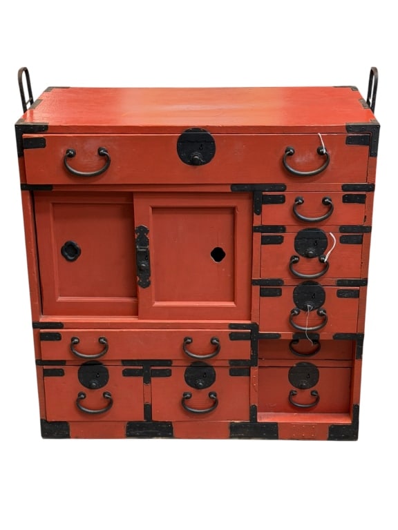 Red Laquered Japanese Tansu Chest: Vintage red-lacquered Edo period Japanese tansu merchant chest, featuring a richly finished red exterior accented by striking black iron hardware. The chest incorporates sliding cabinet doors and