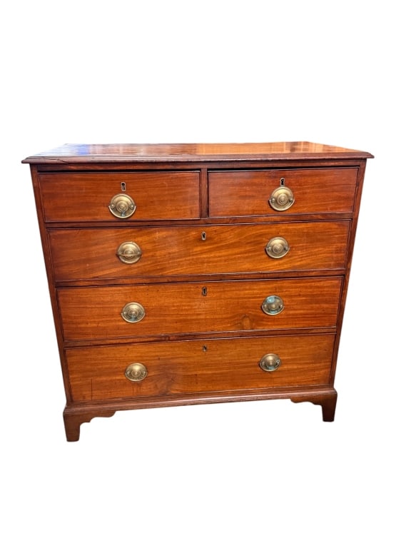 Georgian-Style Mahogany Chest of Drawers: Mahogany chest of drawers with two short drawers over three graduated long drawers, cockbeaded drawer fronts, working locks with escutcheons, brass rosette pulls, and shaped bracket feet. Dovetailed d