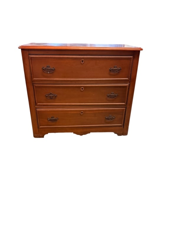 Scottish Pine Cottage Chest: Country pine cottage chest of three graduated drawers with rounded-corner top, ornate stamped brass bail pulls, working locks, and shaped skirt with turned/carved feet. Old finish with expected wear, 