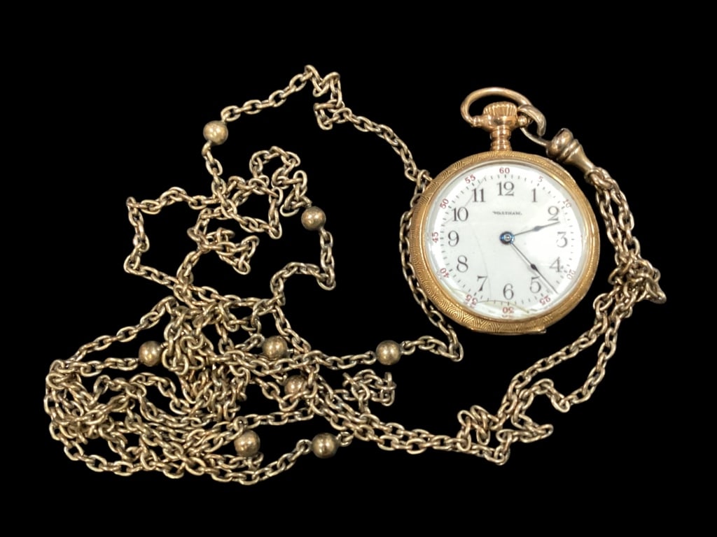 Waltham Pendant Watch: 14 k half Hunter case with engraving. Beveled glass, 1 inch diameter. Marked 14 k, 585, 100 Fine #300201. With accompanying long chain