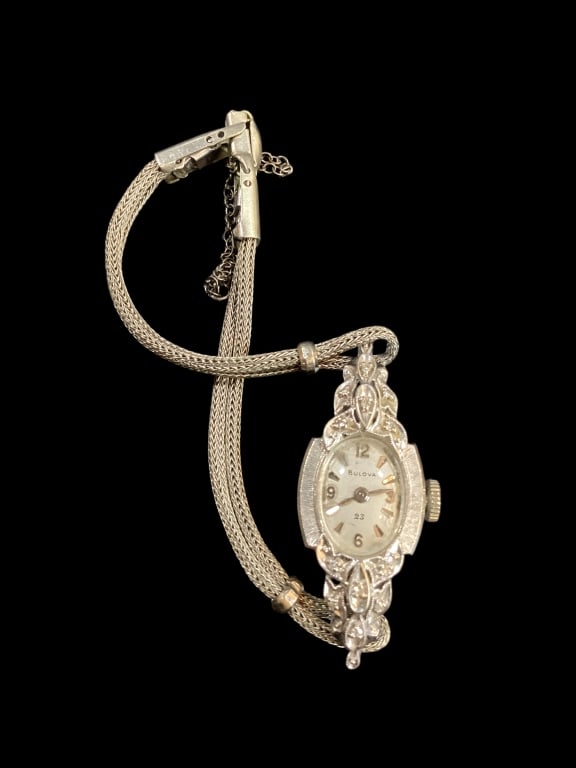 14 k White Gold Cocktail Watch: Made by Bulova, delicate white gold setting with diamond accent ladies cocktail Watch. Mesh multi strand band, ornate surround.