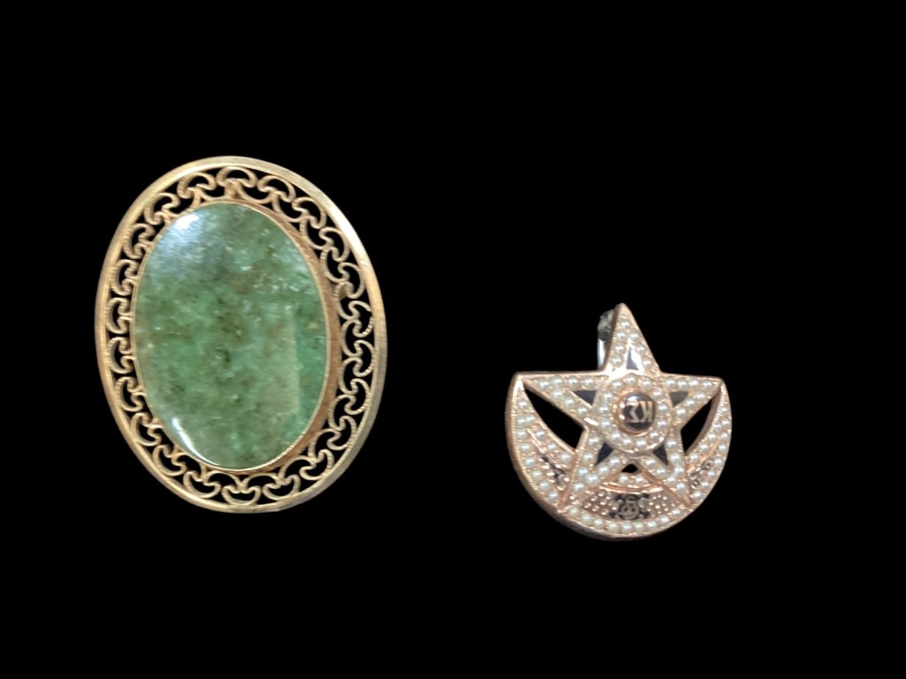 Two Gold Pins: Vintage oval green cabochon stone brooch set inside a 12 k gold filigree frame. College Fraternity Pin featuring a five point star framed by a crescent moon, adorned with seed pearls, set in 10 k gold