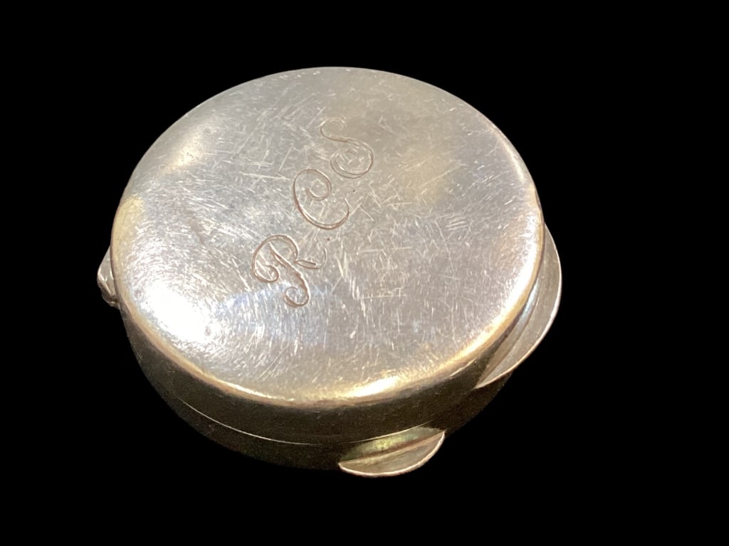 Tiffany Sterling Snuff Box: Polished Sterling silver snuff box, 1 1/2 inch diameter, with lip and thumb opening. Interior stamped Tiffany and 928.