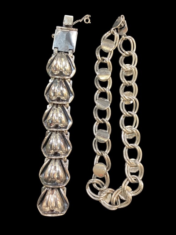 Two Silver Finished Jewelry Articles: 7 inch link bracelet with double lobed puffed heart styling, with some elements of Mexican design, unmarked, Double looped link circular brushed metal disks, 14 inch chain. No marks or hall marks.