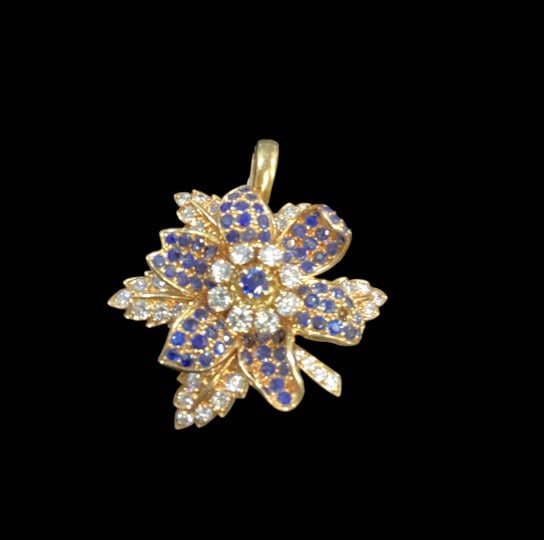 18 K Gold Pendant: Vintage Gubelin Floral design pendant, arranged as a layered flower, set with sapphire stones, and brilliant cut diamonds, 8 diamonds surround a central sapphire stone. Stunning, marked 750 ( 18 k)