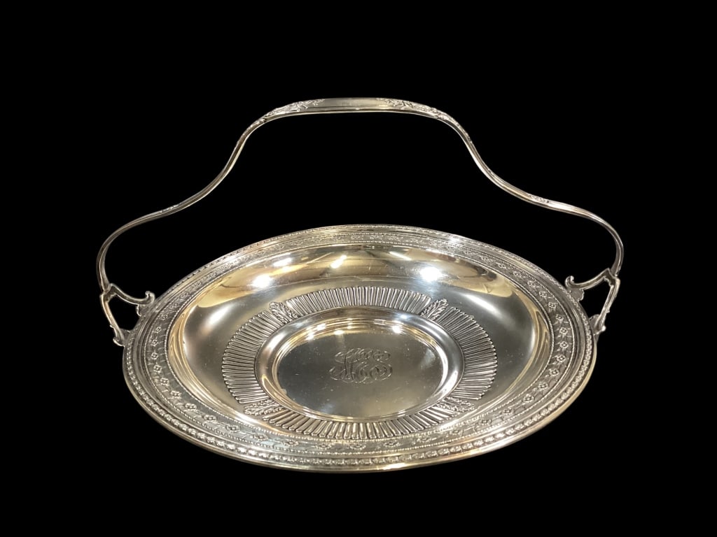 Sterling Silver Table Basket: Bailey, Banks and Biddle Company, lovely curved handle, Repousse rim, interior monogram. 9 inch diameter, ( 8.68 ozt approximately).