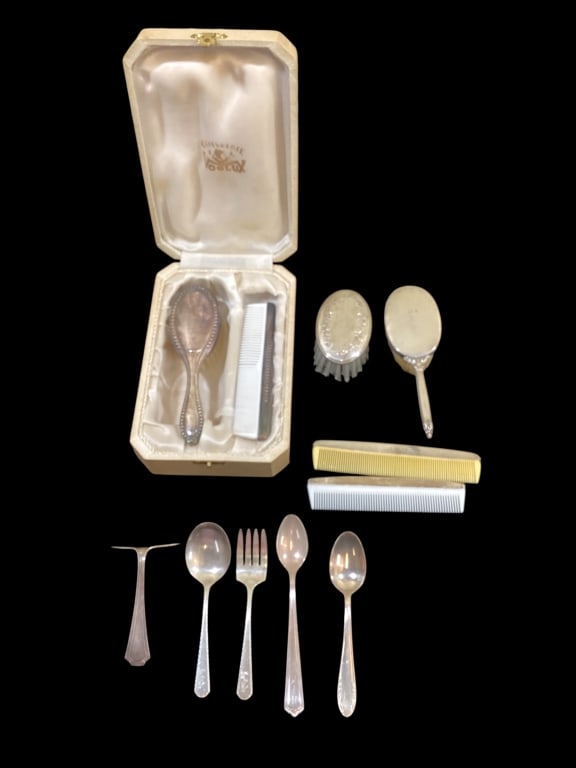 Mixed Group Sterling and Plate Baby Items: Sterling handle baby brush, oval Sterling brush by Lullaby, 2- Sterling housed baby combs. Silver plate comb and brush set in box. Sterling food push, Weidlich Sterling baby spoon and fork, Webster