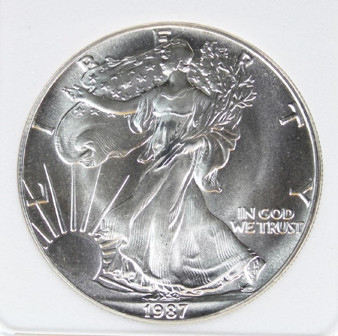 1987 AMERICAN SILVER EAGLE: PERFECT SUPERB BU. TDCS GRADED. ESTIMATE: $600-$650