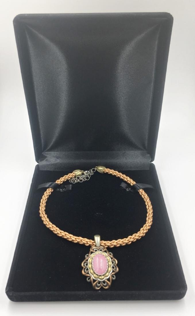 NECKLACE WITH PENDANT: WOVEN ROPE--COPPER/RED BRASS NECKLACE. PENDANT STAMPED "COPPER BRASS"--HAS A ROSE COLORED STONE. COMES WITH BOX. PRE-OWNED. SEE PHOTOS. ESTIMATE: $75-$100