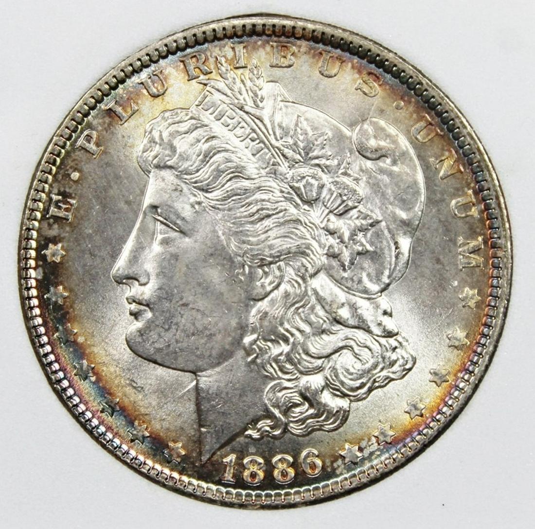 1886 MORGAN DOLLAR: WHSG GRADED. SUPERB BU. PRETTY RIM COLORS. ESTIMATE: $600-$650