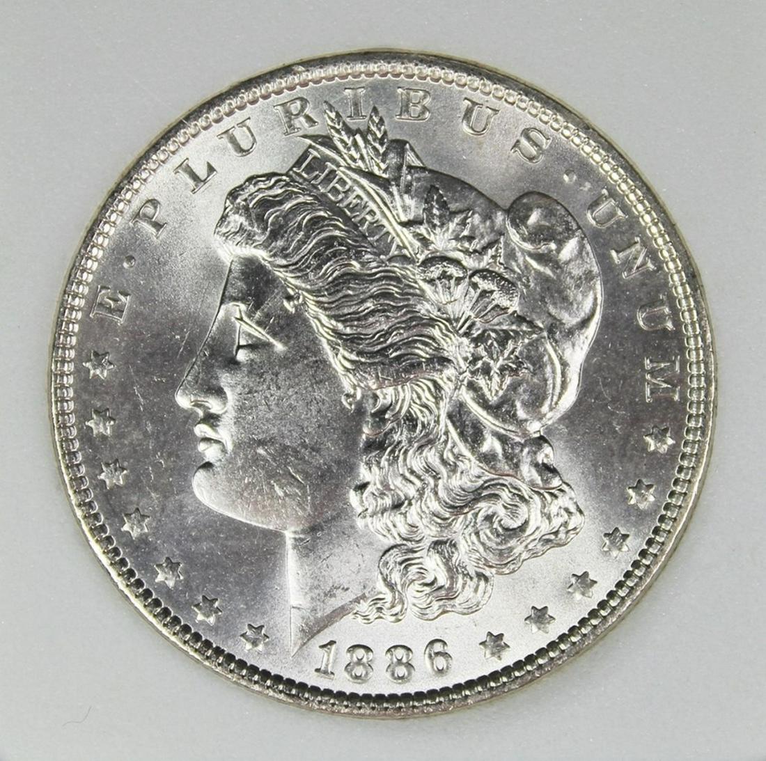 1886 MORGAN SILVER DOLLAR: CCGS GRADED SUPERB BU BLAST WHITE! ESTIMATE: $650-$750