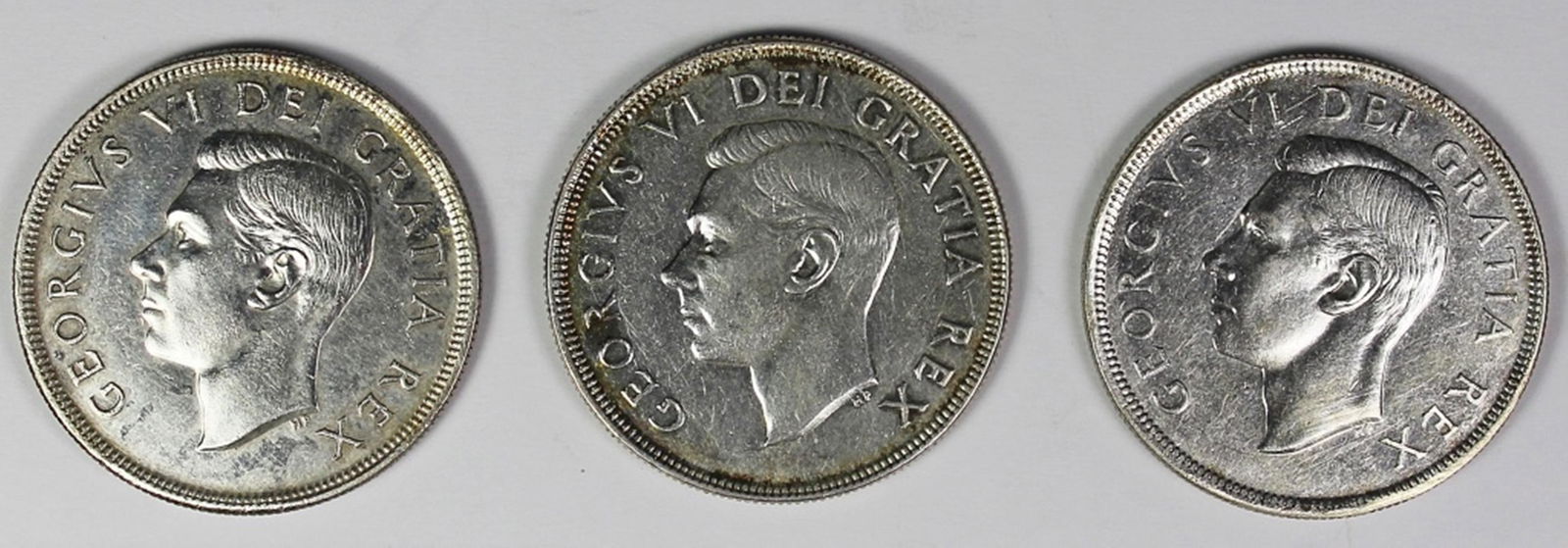 THREE CANADA SILVER DOLLARS (1 of 2)