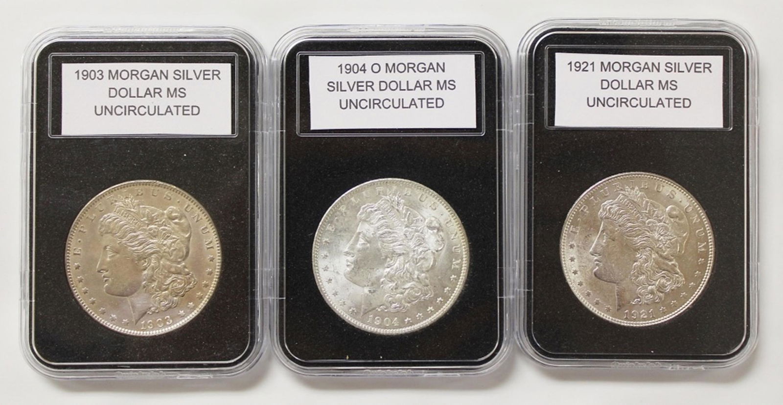 THREE MORGAN SILVER DOLLARS: (1 of 2)