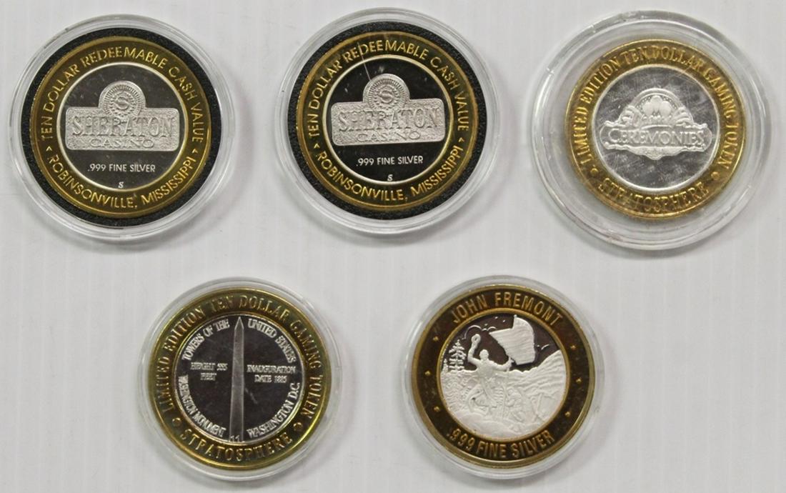 FIVE MISCELLANEOUS SILVER CASINO TOKENS (1 of 2)
