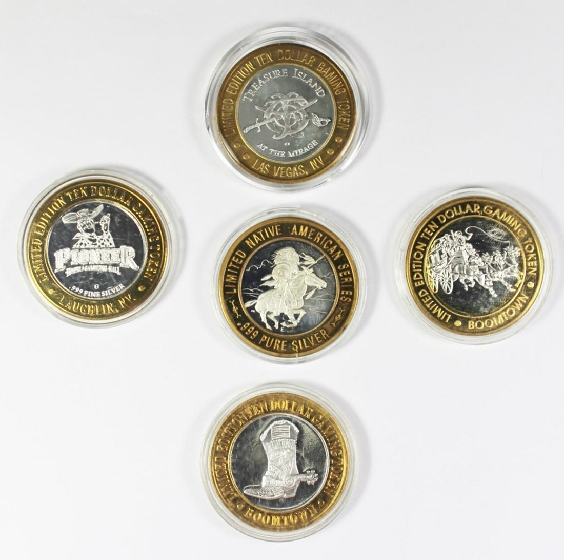 FIVE MISCELLANEOUS SILVER CASINO TOKENS (1 of 2)