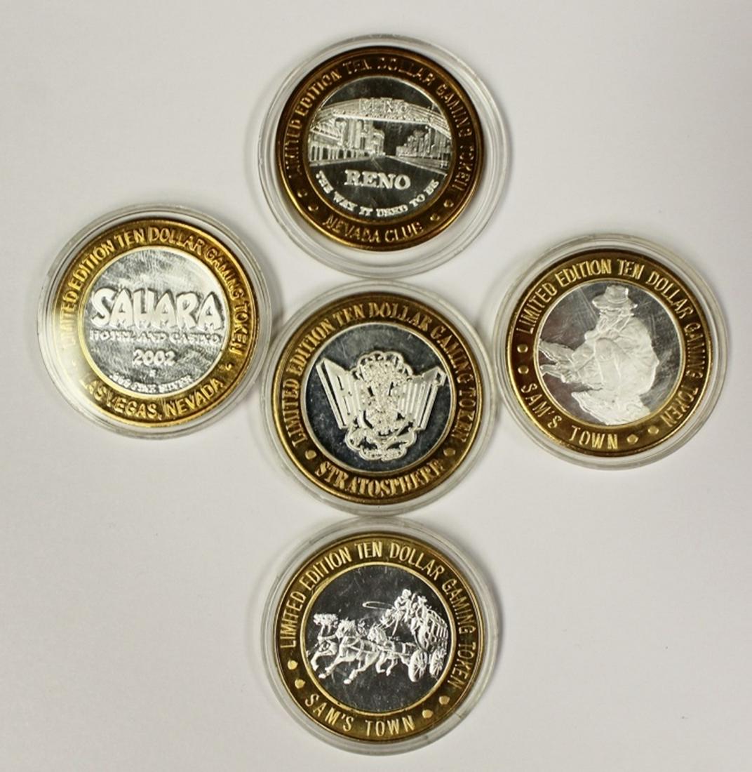 FIVE MISCELLANEOUS SILVER CASINO TOKENS (1 of 2)