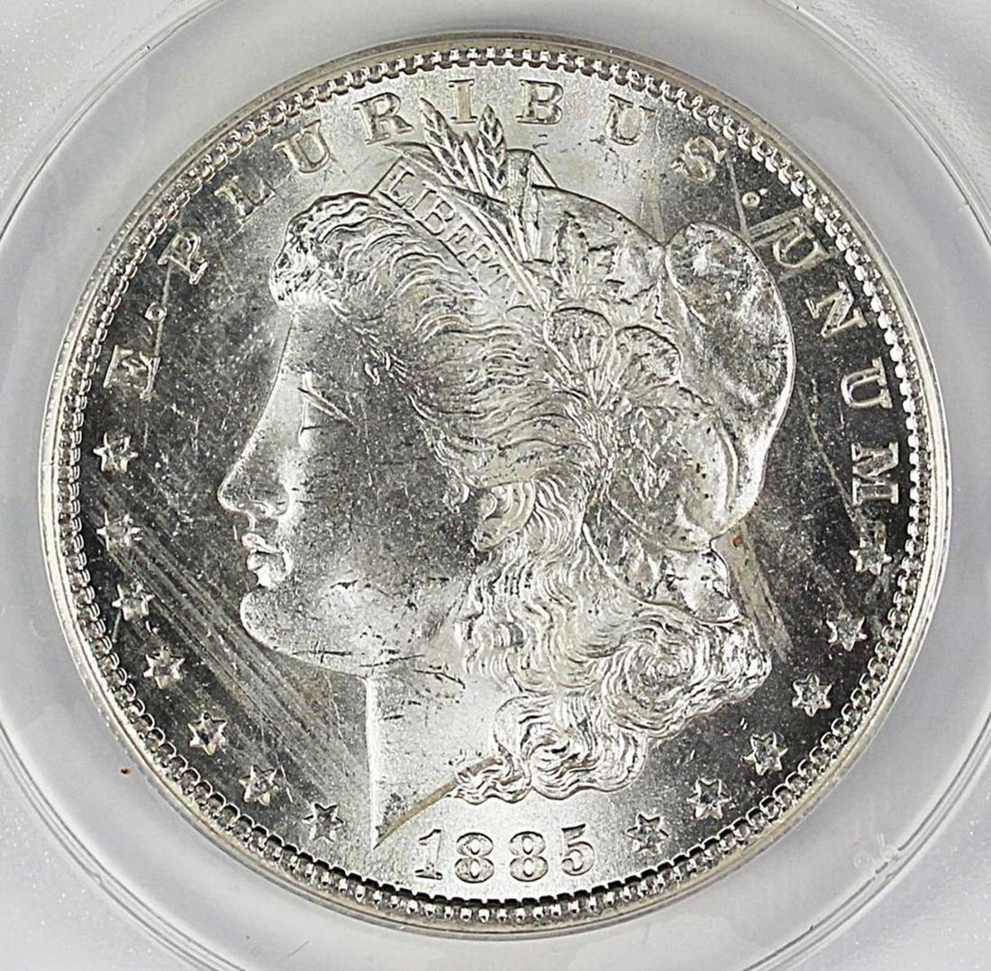 1885-CC MORGAN SILVER DOLLAR: ANACS MS 63 WHITE KEY DATE. ESTIMATE: $650-$850