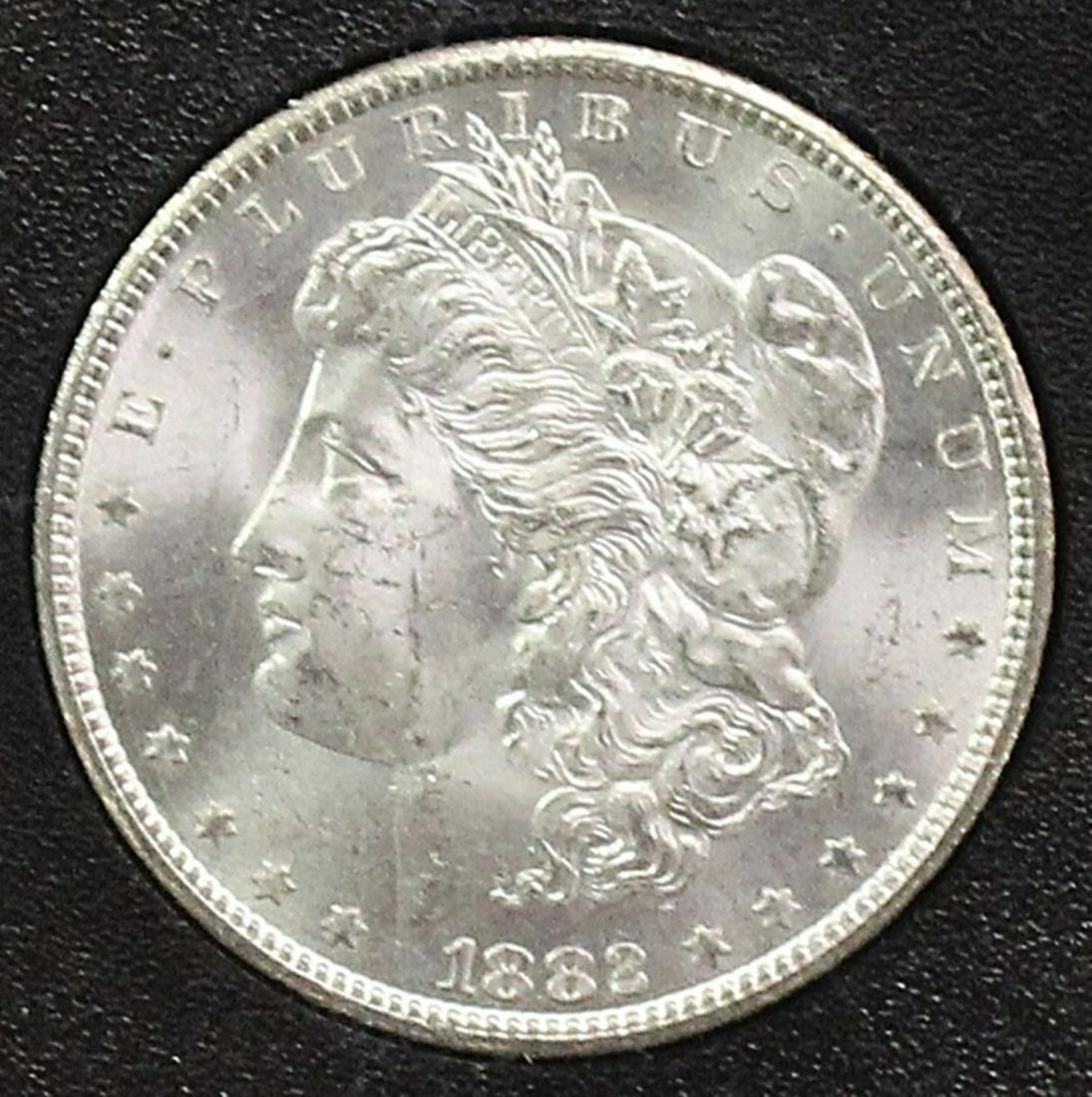 1882-CC MORGAN SILVER DOLLAR: GSA GRADED. COMES WITH BOX AND CERT. GEM BU+ ESTIMATE: $365-$425