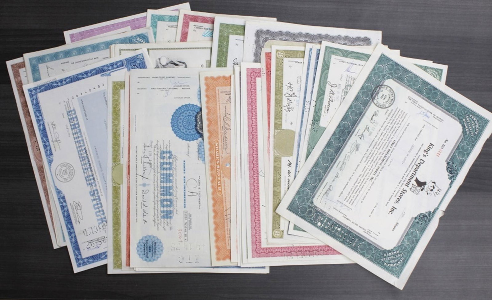 (50) LARGE STOCK CERTIFICATES: CERTIFICATES. XF+. COLORFUL AND NEAT LOOKING. INTERESTING! VARIOUS DATES. WHO KNOWS WHATS ALL HERE? WE ONLY COUNTED THEM! ESTIMATE: $200-$250