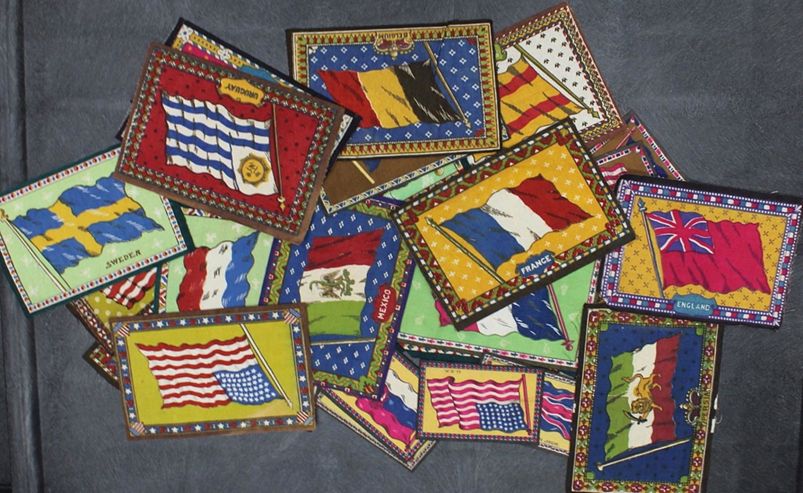 (30) SWATCHES WITH VARIOUS FLAGS: VARIETY OF FLAG FROM DIFFERENT COUNTRIES ON FABRIC SWATCHES. SIZES VARY FROM 5"X3", 6"X3.5", AND 8.5"X5.5". ESTIMATE: $30-$50