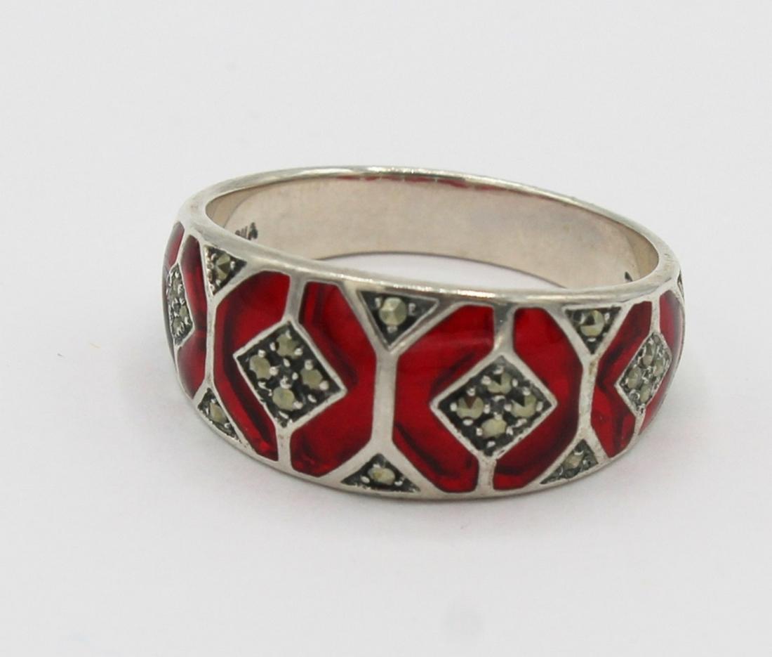 STERLING SILVER RING: SIZE 9.5 STERLING SILVER RING WITH RED ENAMEL. 4.2 GRAMS. ESTIMATE: $20-$40