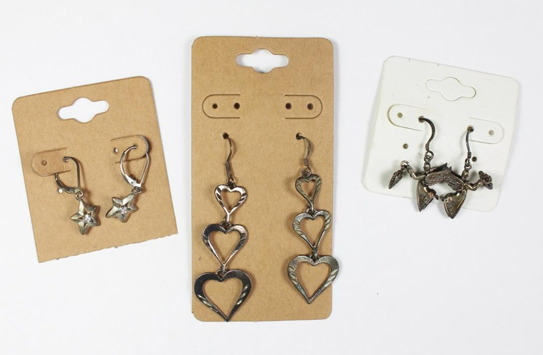 (3) PAIRS OF STERLING SILVER EARRINGS: STARS, ANGELS AND HEART DESIGNS. 14 GRAMS TOTAL. ESTIMATE: $50-$75