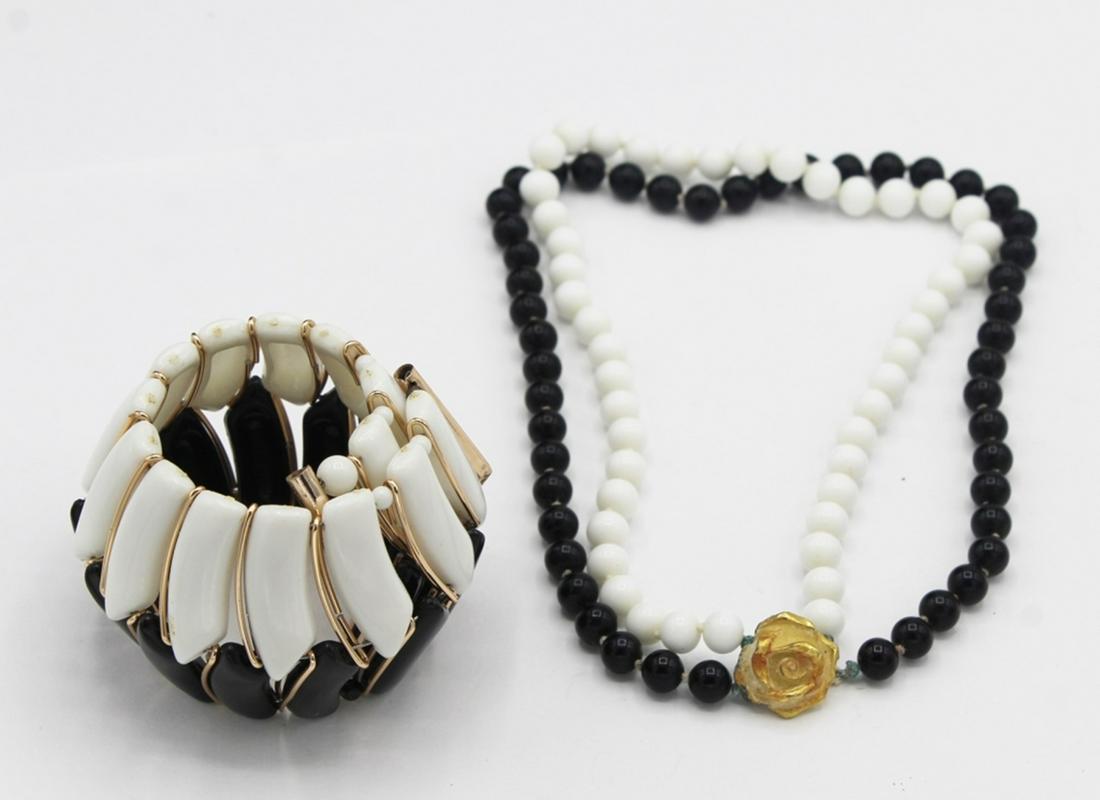 BLACK AND WHITE NECKLACE AND BRACELET: BLACK AND WHITE W/ GOLD TONES. NECKLACE IS DOUBLE STRAND AND THE BRACELET IS A WIDE CUFF. ESTIMATE: $25-$30