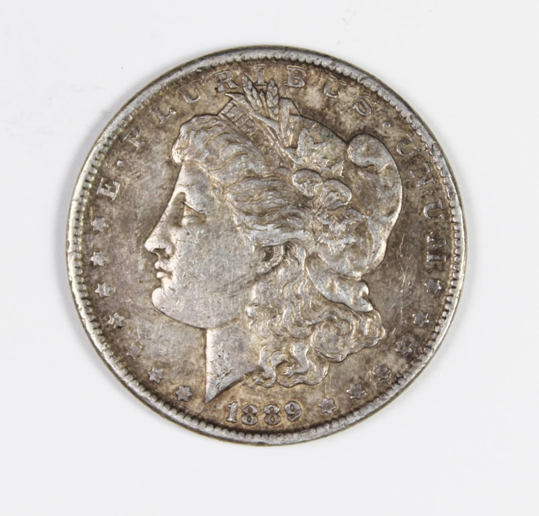 1889 MORGAN SILVER DOLLAR: SLIGHT LUSTRE AND TONING. VG. ESTIMATE: $100-$150