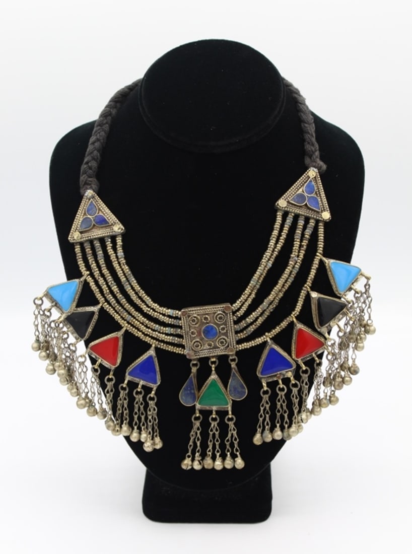 AFGAN ETHIC TRIBAL LAPIS NECKLACE: SILVER NECKLACE WITH LAPIS, CORAL, MALACHITE AND TURQUOISE STONES. WEIGHS 136-.7 GRAMS. BLACK BRADIED YARN WITH EXTENDED NECKLACE AND BUTTON CLOSURE. PRE-OWNED. ESTIMATE: $100-$200